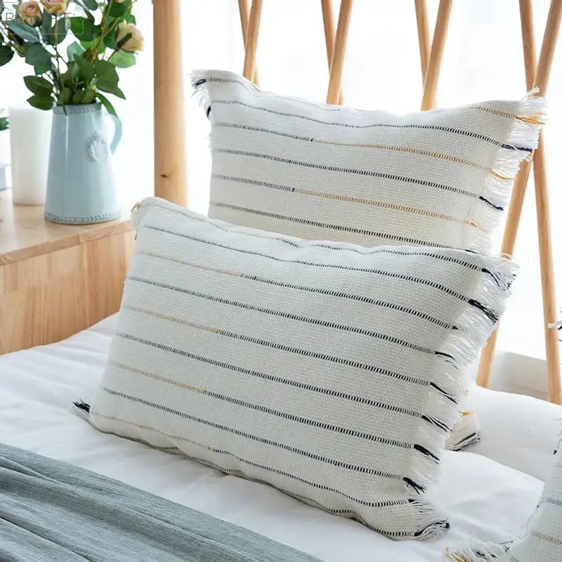 White rectangular throw pillow with black and beige stripes and frayed edges decorbites handmade cotton woven cushion