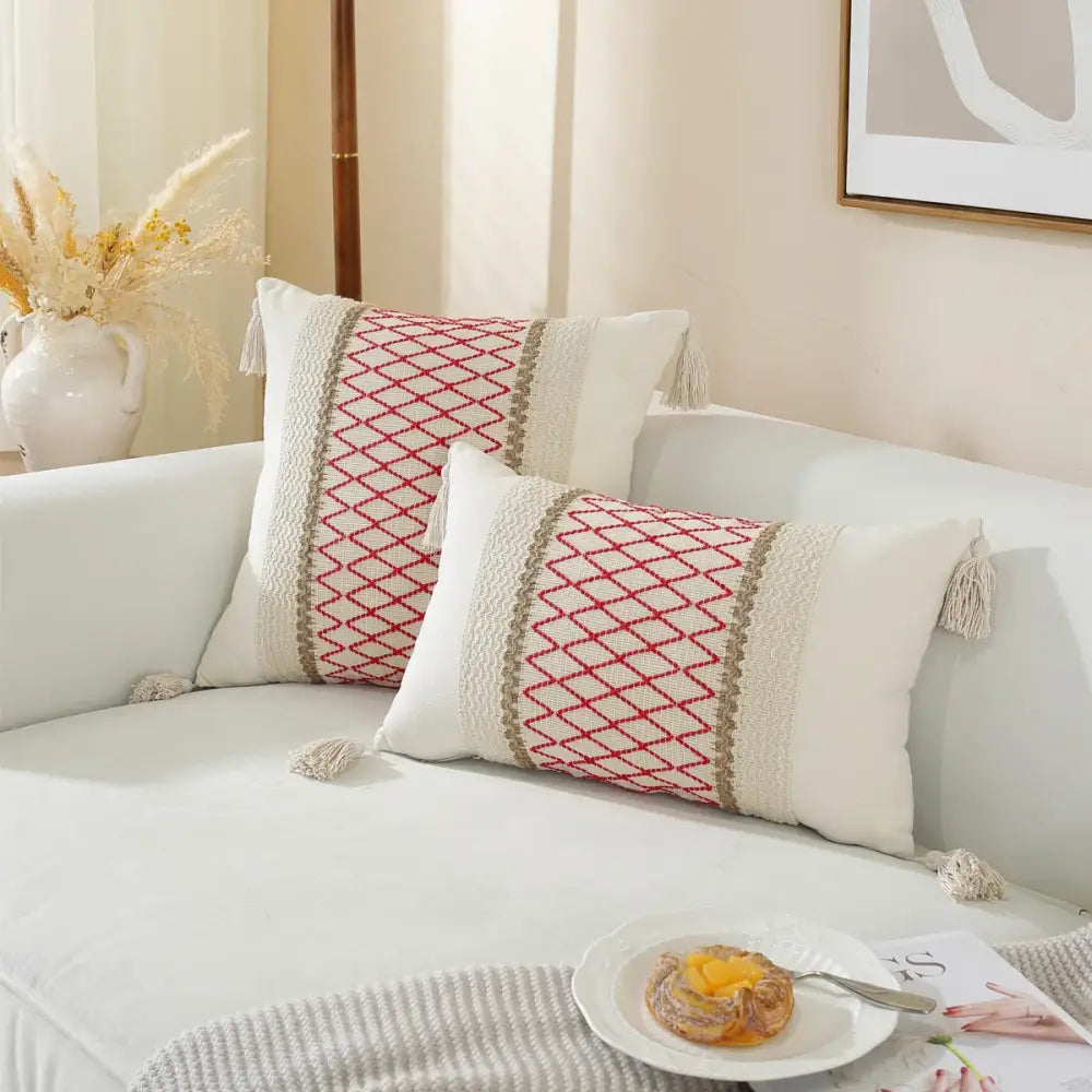 Cream-colored rectangular woven cushion cover with red beige lattice patterns and tassel trim for living room use