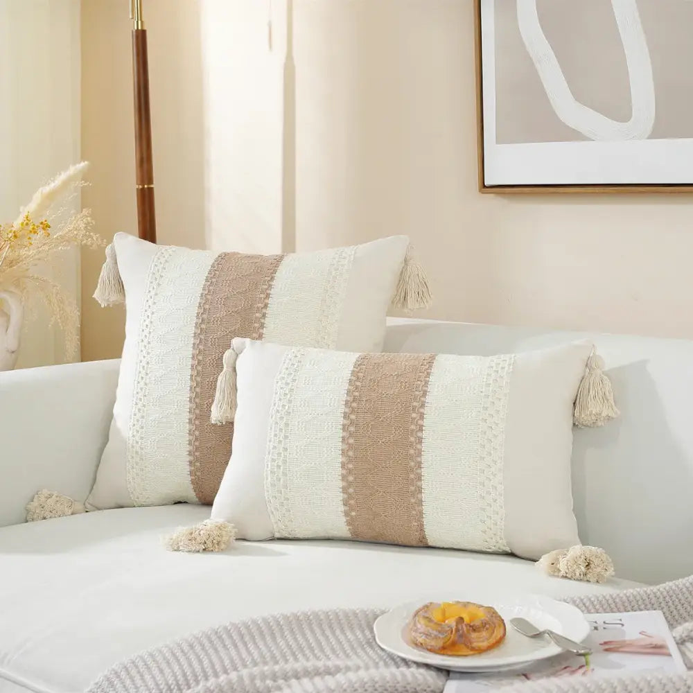 Cream-colored rectangular woven cushion cover with beige stripes and tassel accents for boho living room decor