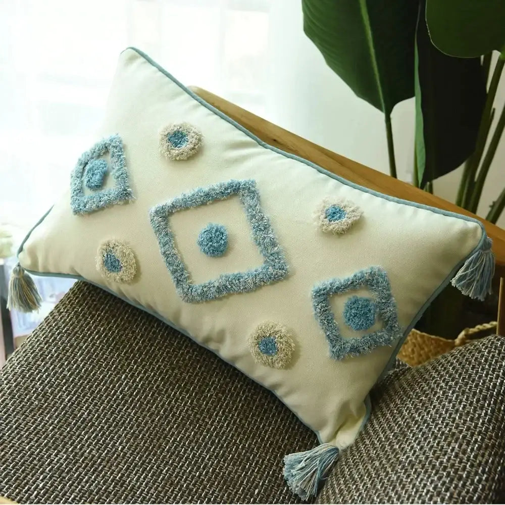 Cream-colored rectangular cushion cover with boho blue diamond embroidery and tassels for living room decorbites boho blue decor