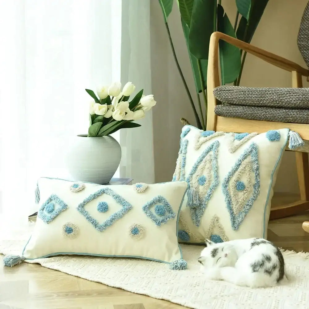 Cream-colored cushion cover with boho blue diamond embroidery and tassel trim for decorbites boho blue decor
