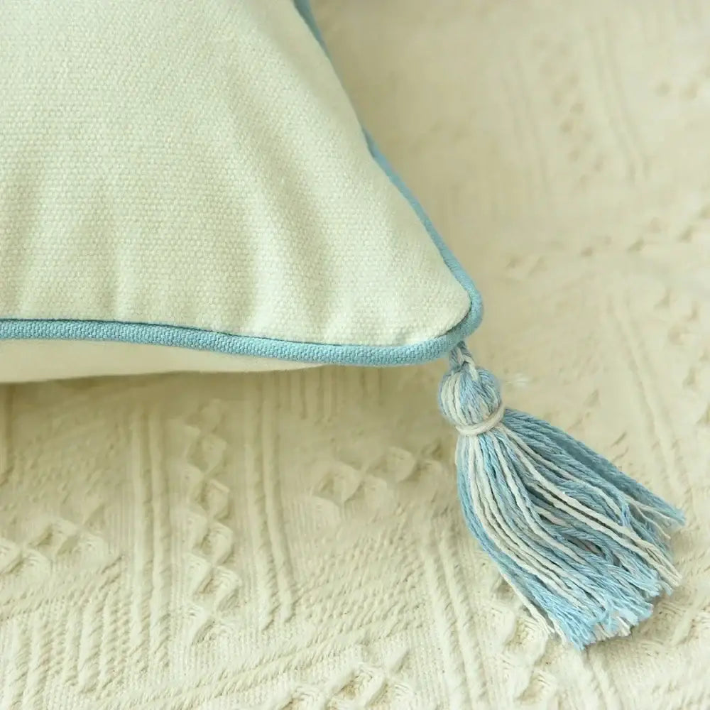Soft mint-green cushion cover with light blue trim and tassel accent from decorbites boho blue diamond collection