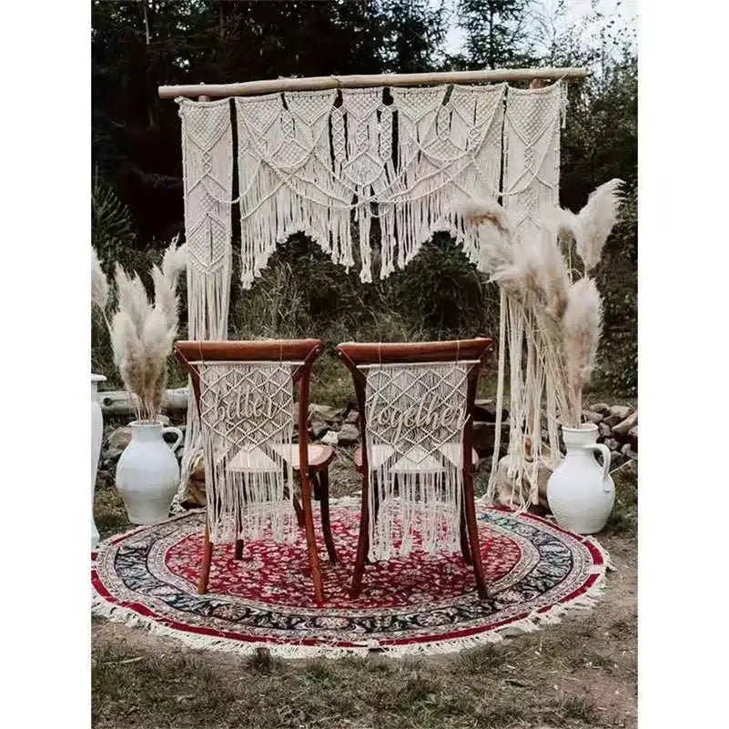 Cream-colored decorbites cotton macrame wedding backdrop with intricate woven patterns and long fringe for boho decor