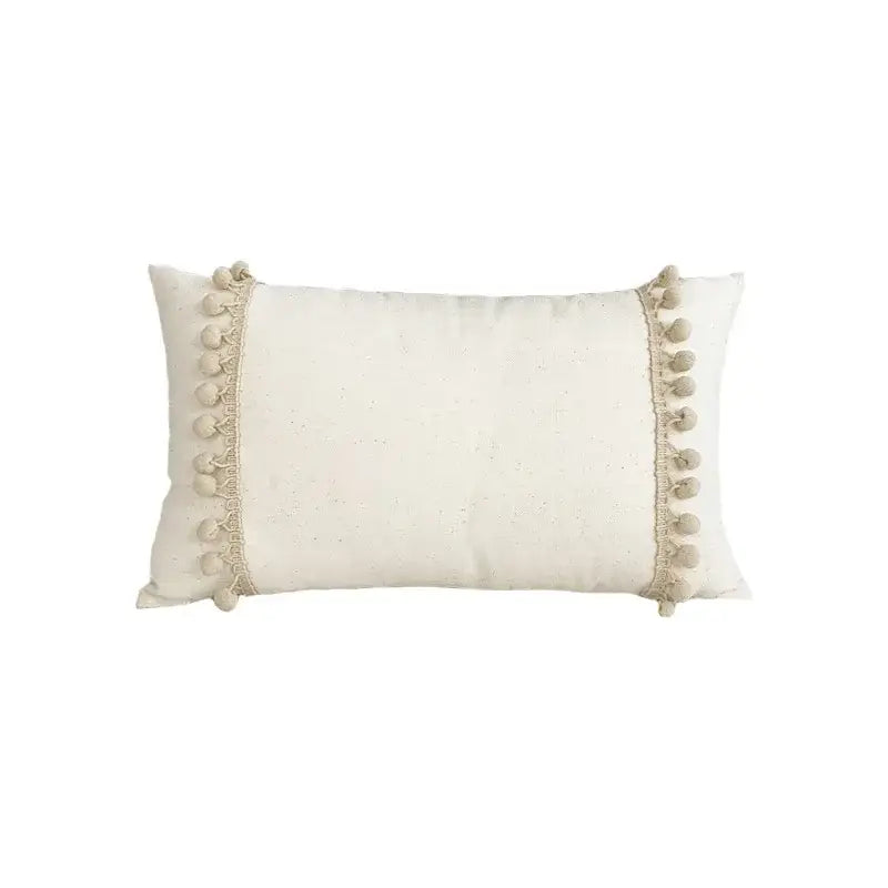 Cream-colored rectangular cushion cover with lace floral design and fluffy pom-poms by decorbites boho white
