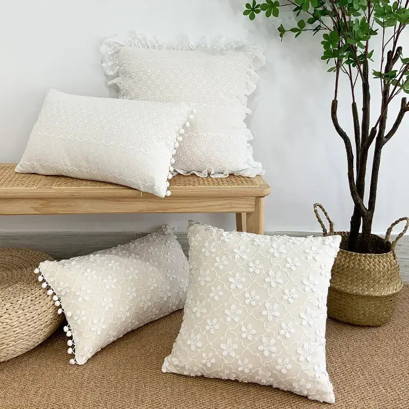 Cream-colored cushion cover with lace floral embroidery ruffled edges and pom pom trim decorbites boho white pillow