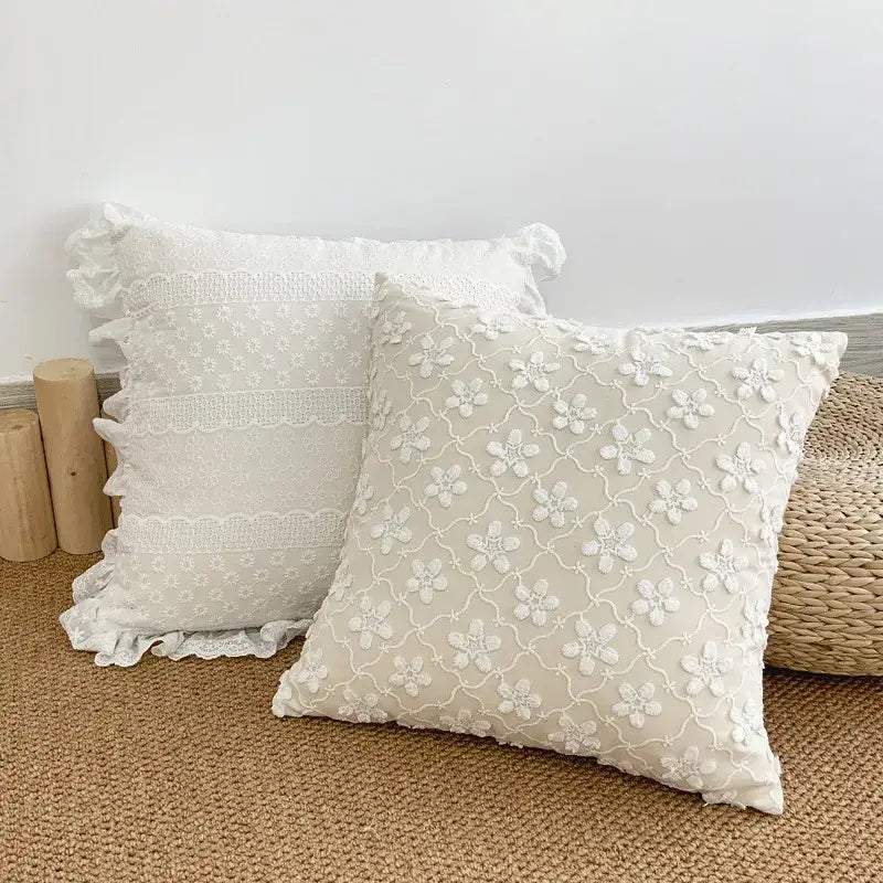 Cream-colored cushion cover with delicate lace floral embroidery and ruffled edges for decorbites boho white decor