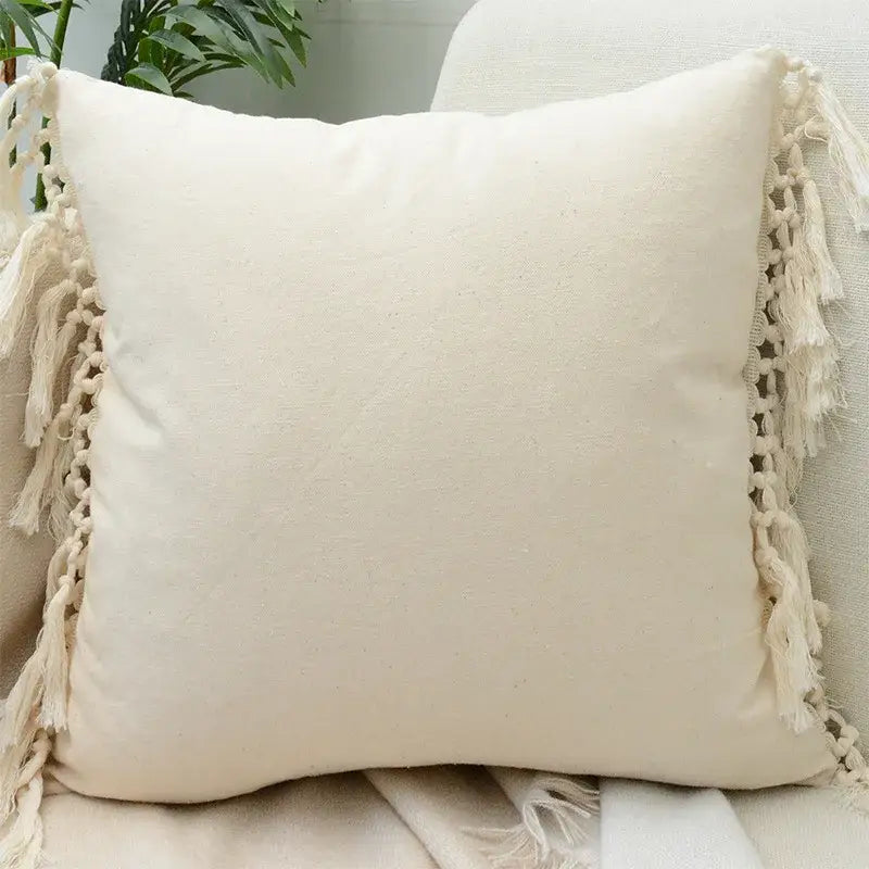 Cream-colored cotton cushion cover with lace floral design and macrame tassels for decorbites boho white style decor