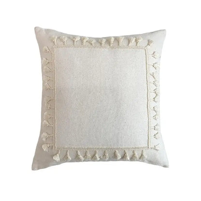 Cream-colored Boho white cushion cover with textured linen fabric lace floral design and decorative tassels by Decorbites