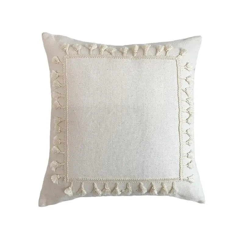 Cream-colored Boho white cushion cover with textured linen fabric lace floral design and decorative tassels by Decorbites