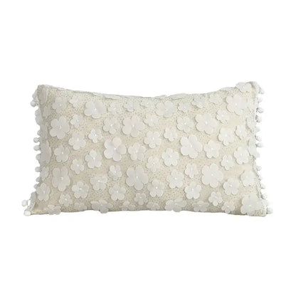 Cream-colored rectangular cushion cover with lace floral appliqués and pom pom trim decorbites boho white pillow decor