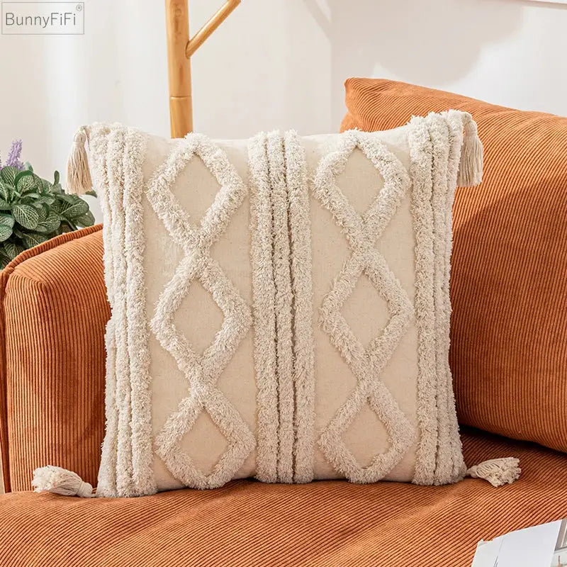 Cream-colored woven boho cotton pillow cover with textured diamond and stripe patterns and tassels for decorbites decor