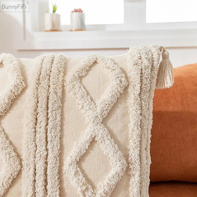 Cream-colored boho cotton pillow cover with textured woven diamond pattern and tassel trim for living room decorbites decor