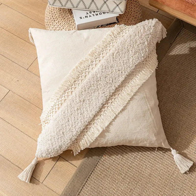 Cream-colored boho cotton pillow cover with a textured fringed diagonal band and tassels for living room decorbites decor