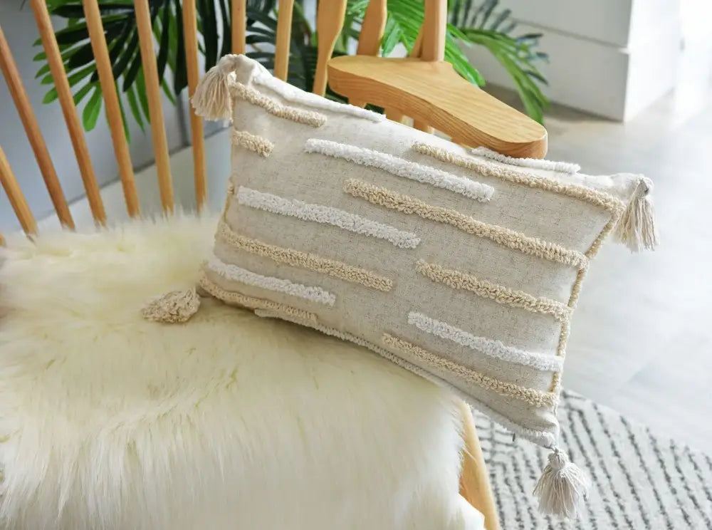 Beige rectangular throw pillow cover set with cream textured horizontal stripes and corner tassels for bedroom decor