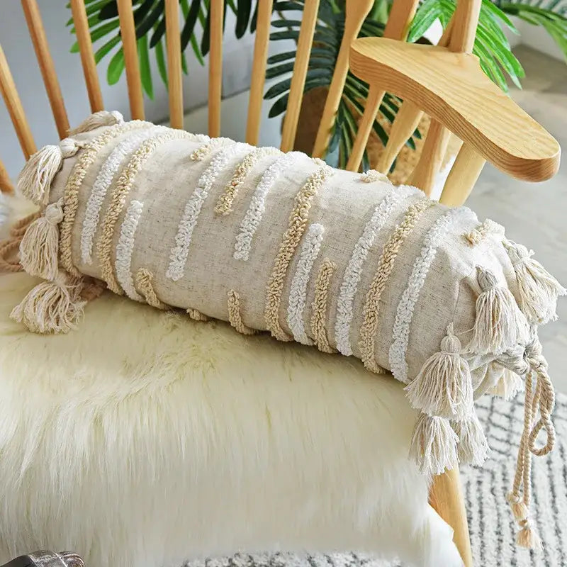 Beige cylindrical boho pillow cover set with textured woven stripes and tassels for bedroom decor