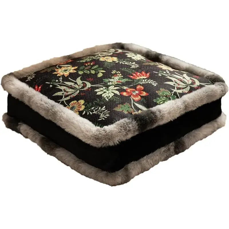Square-shaped cushion with a dark floral patterned fabric top, trimmed in soft gray faux fur along its edges and base.