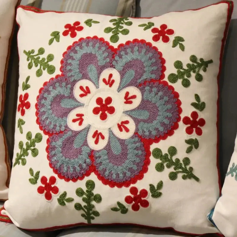 A cream-colored flower elephant pillowcase with vibrant embroidered ethnic flower design in pink and teal decorbites style