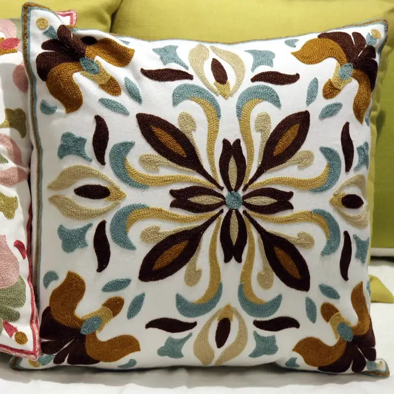 White cushion with intricate brown gold and teal embroidered floral design for decorbites ethnic flower pillowcase