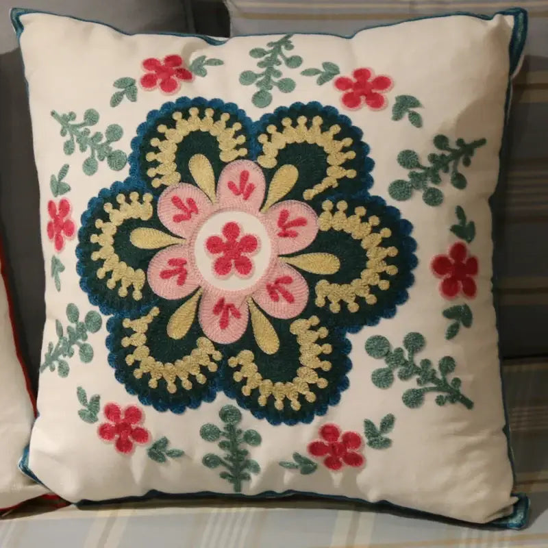 A cream-colored flower elephant pillowcase with intricate pink yellow and teal embroidered floral patterns for decorbites ethnic flower decor
