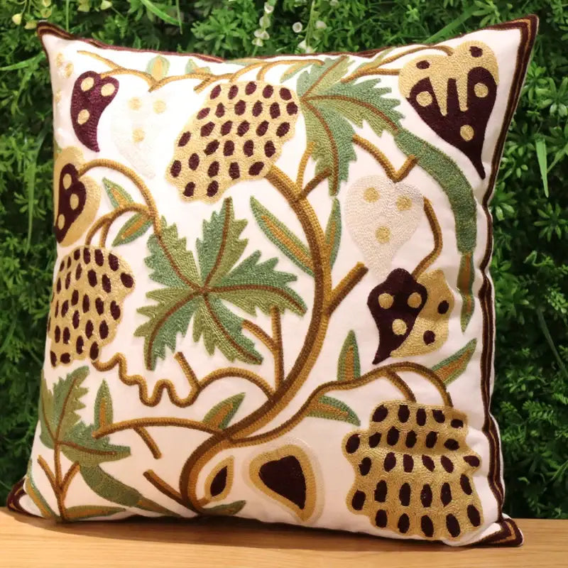 A cream-colored ethnic flower elephant pillowcase with embroidered botanical patterns in green brown and gold for decorbites ethnic flower decor