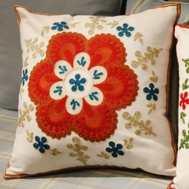 Cream-colored flower elephant pillowcase with vibrant orange embroidered flower and gold leaf decorbites ethnic flower design