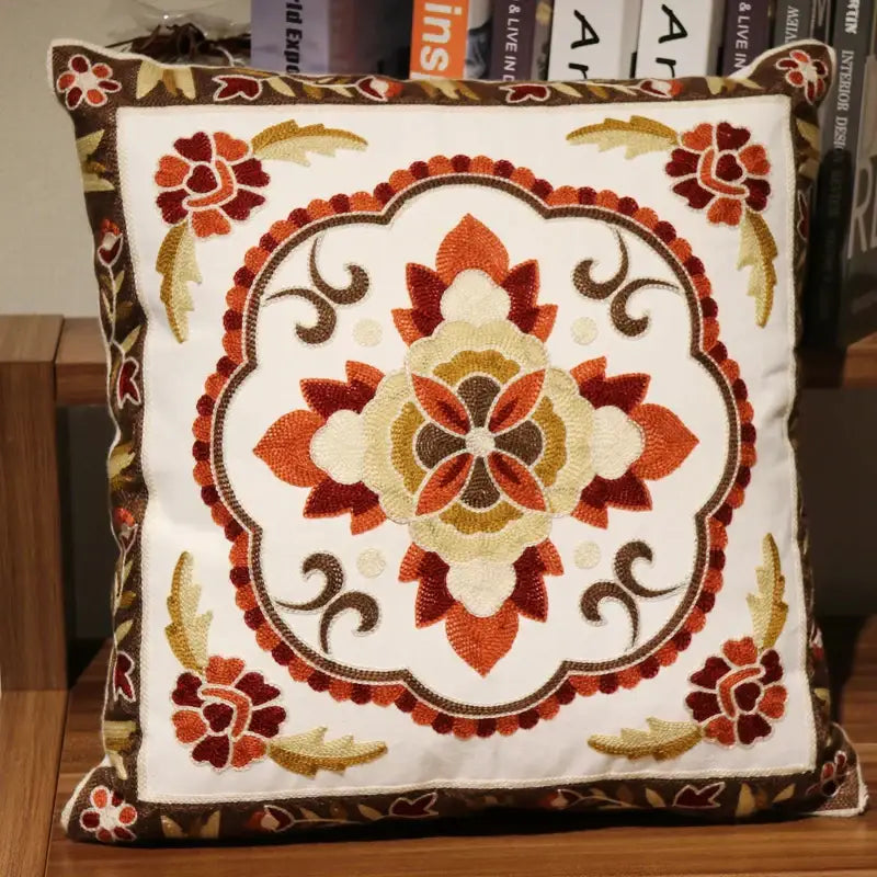 A square decorative boho ethnic flower elephant pillowcase with embroidered floral patterns in orange brown and cream