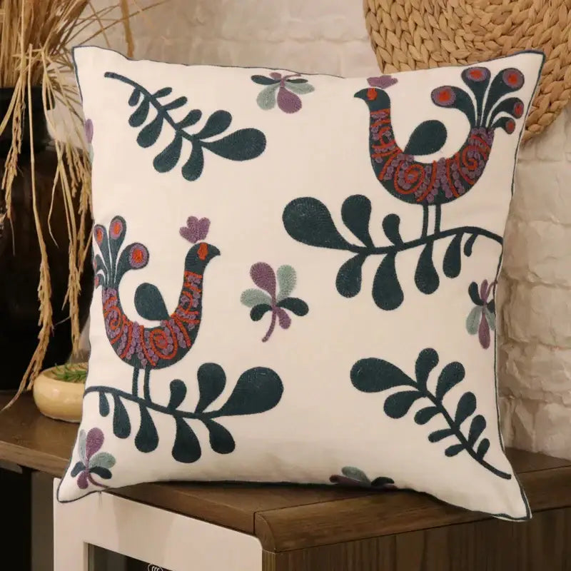 White cushion with embroidered stylized birds in red purple and dark green on cream decorbites ethnic flower pillowcase