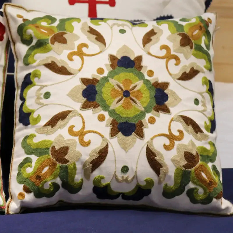 A square boho ethnic flower elephant pillowcase with green brown and navy embroidered floral patterns on white fabric