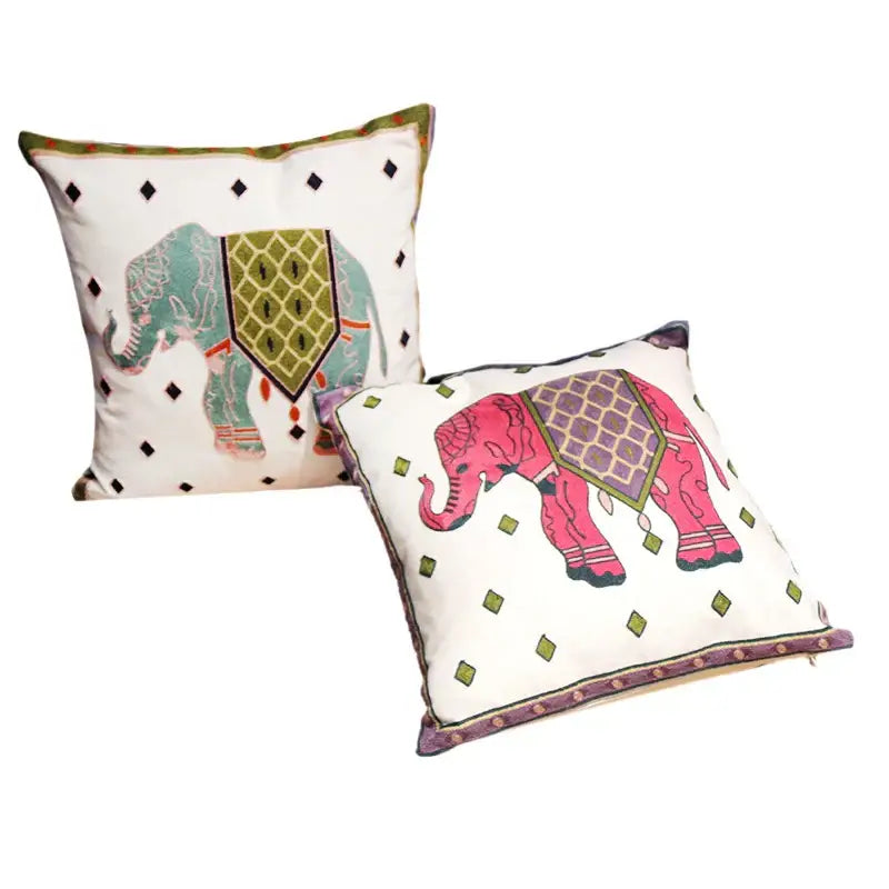 Two decorative throw pillows with embroidered pink and teal ethnic flower elephant design on white decorbites ethnic flower pillowcase