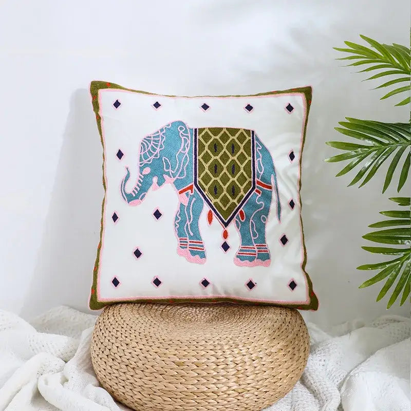 A square white pillow cover with a teal and pink embroidered elephant and black diamond border for decorbites boho farmhouse floral decor