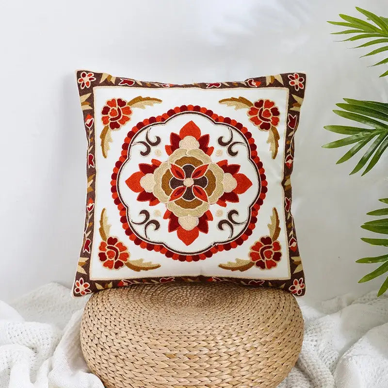 Square pillow cover with intricate red orange and brown embroidered floral design on cream decorbites boho farmhouse style