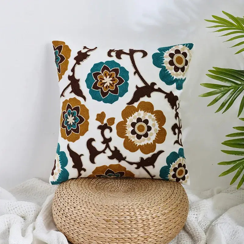 A boho farmhouse floral cream embroidered pillow cover with teal and brown floral patterns for living room decorbites decor