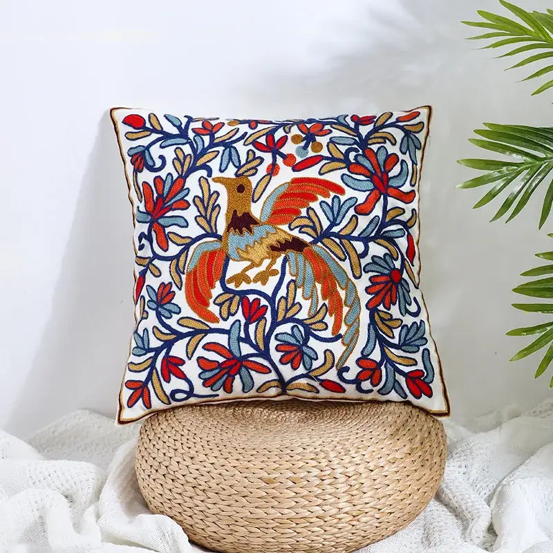 Boho farmhouse floral cream embroidered pillow covers with vibrant red blue orange and gold floral bird designs on white background