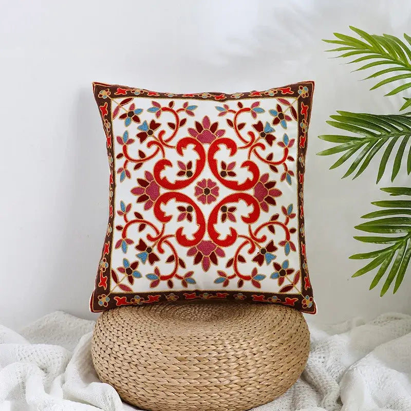 Boho farmhouse floral cream embroidered pillow cover with intricate red pink and blue floral design and dark brown border