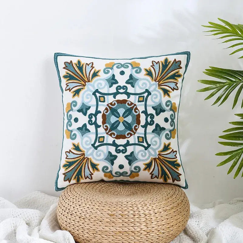 Boho farmhouse floral pillow covers featuring teal blue and gold embroidered patterns on a cream decorbites fabric