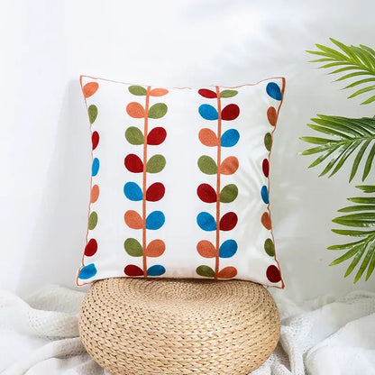 White pillow cover with colorful embroidered leaves on beige woven base for decorbites boho farmhouse floral decor