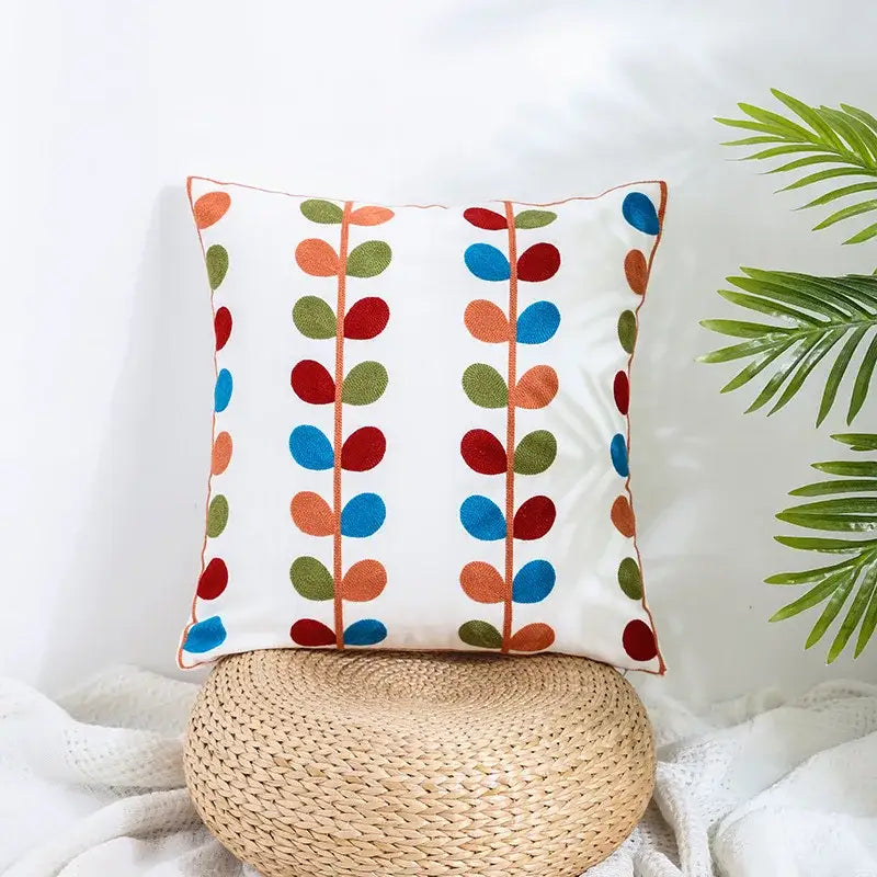 White pillow cover with colorful embroidered leaves on beige woven base for decorbites boho farmhouse floral decor
