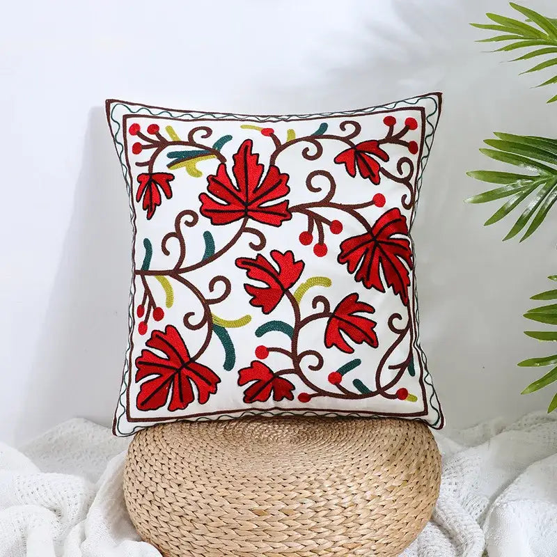 White square pillow cover with vibrant red green and brown embroidered leaves on cream decorbites boho farmhouse floral fabric