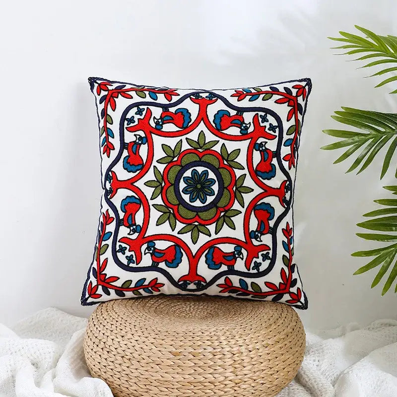 Boho farmhouse floral cream pillow covers featuring vibrant red blue and green embroidered floral pattern for living room decorbites