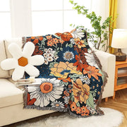 Cozy boho floral cotton blanket in navy blue with vibrant orange white yellow pattern and fringed edges for decorbites throw