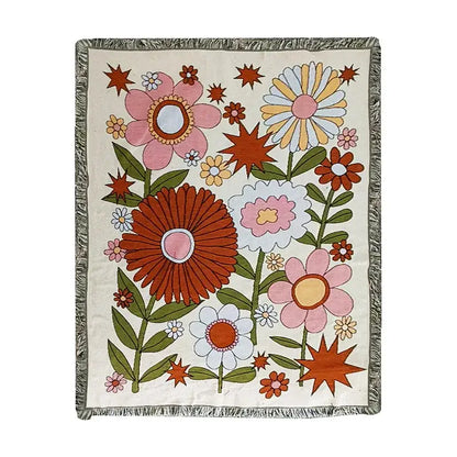 A cream-colored boho floral cotton blanket with vibrant retro blossoms and green leaves for decorbites boho floral throw