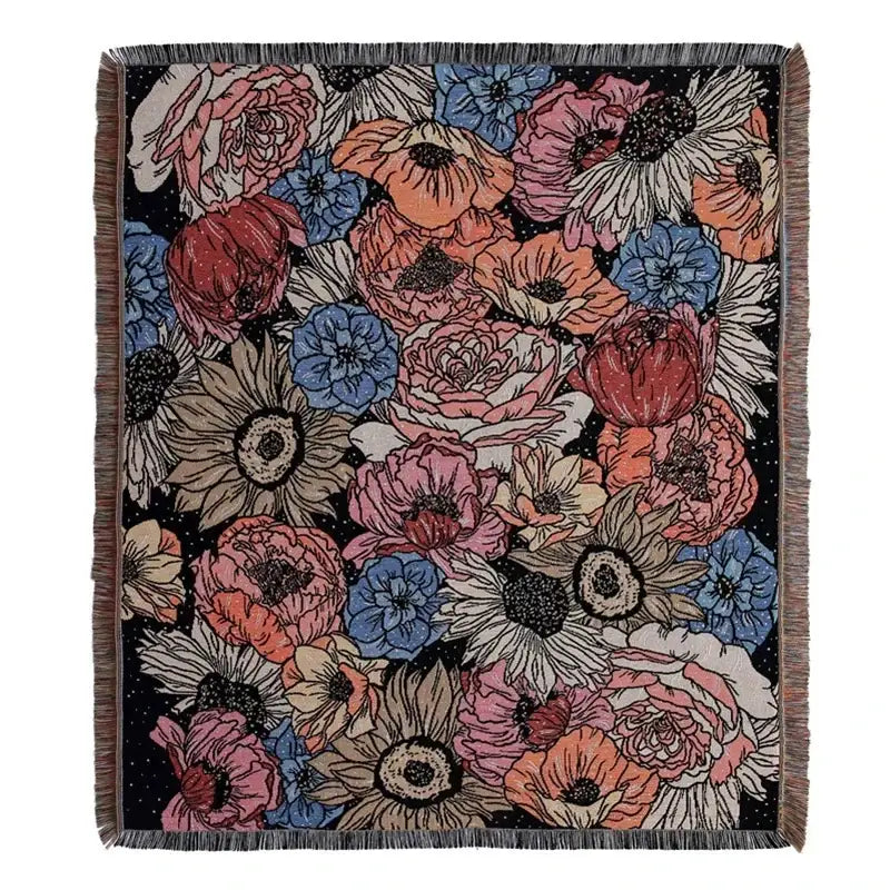 A boho floral cotton blanket featuring vibrant pink, blue, orange, and beige blossoms on navy blue decorbites boho floral throw