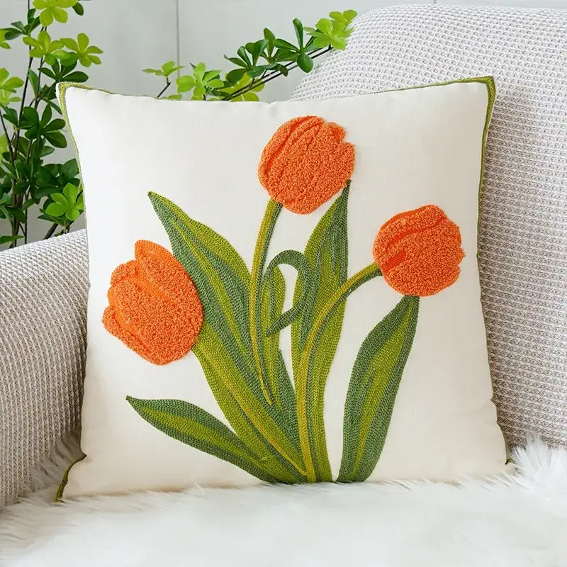 White square cushion cover with boho floral embroidered orange tulips and green stems by decorbites in textured fabric