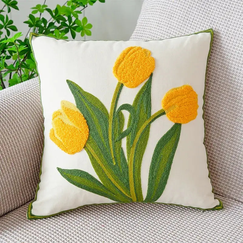 White cushion cover with vibrant yellow tulips and green leaves boho floral embroidered decorbites design
