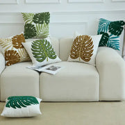 White throw pillow with boho floral embroidered green and brown monstera leaves cushion cover by decorbites