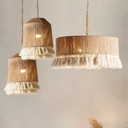 Three rustic pendant lights with natural wood-toned woven bodies and white tassel fringes by decorbites boho fringe hemp