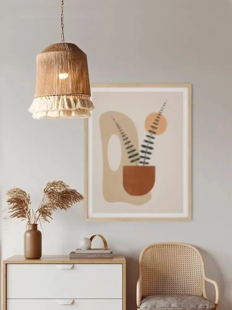 A woven, beige pendant lamp with a fringed tassel detail.