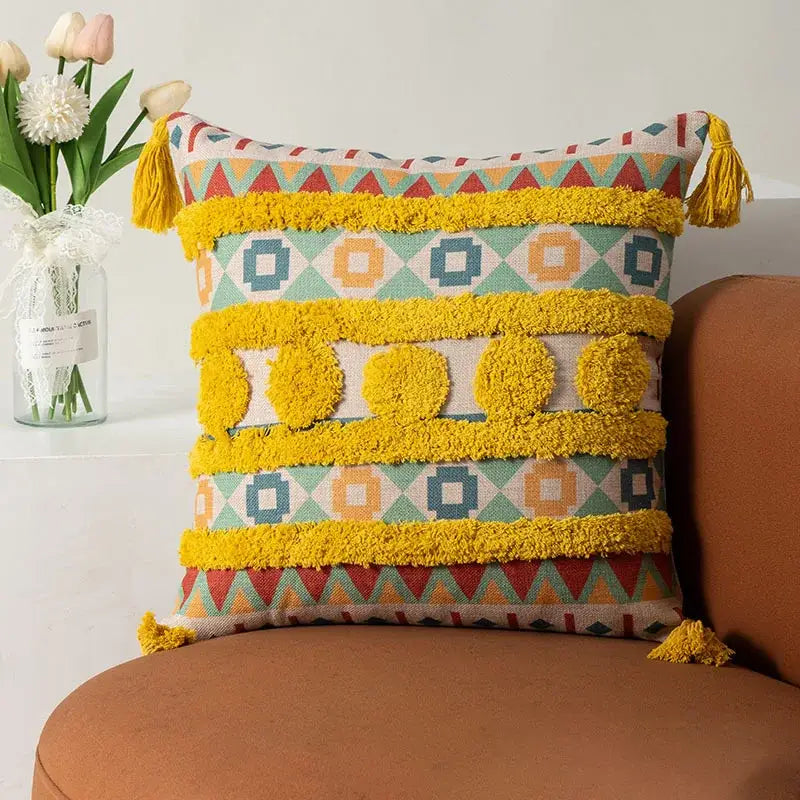 Vibrant geometric-patterned boho fringe pillow cover with bold yellow tassels and textured pom-poms for living room decorbites decor