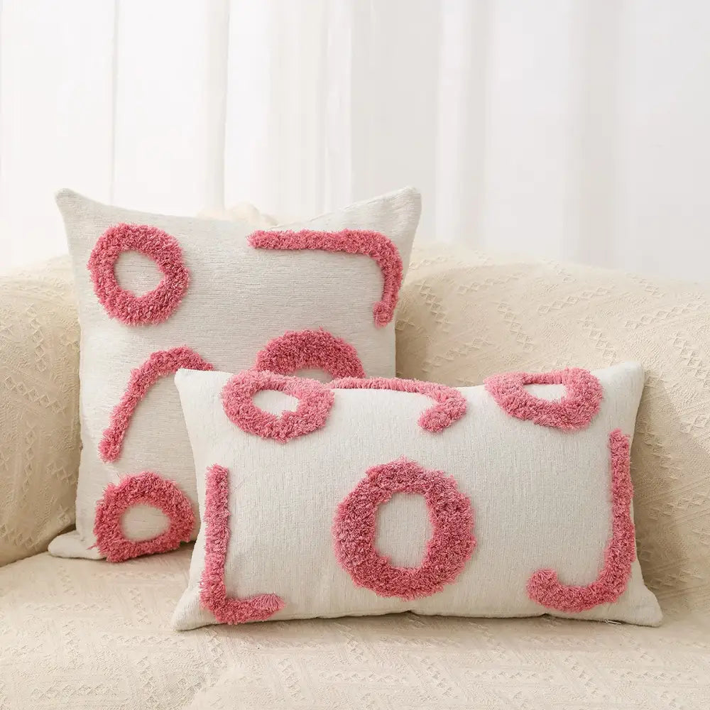 Cream-colored rectangular throw pillow with pink fuzzy lol lettering and matching square pillow in decorbites geometric chenille embroidered pillow covers set