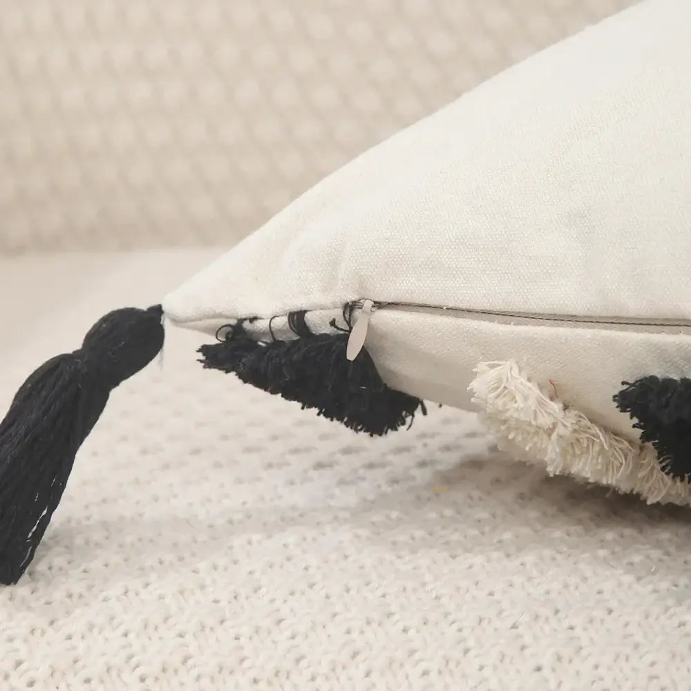 White cushion with black tassels and frayed edges in decorbites geometric chenille embroidered pillow covers set for living room